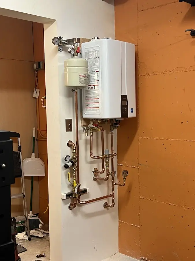Plumbing technician inspecting water heater connections in Walla Walla